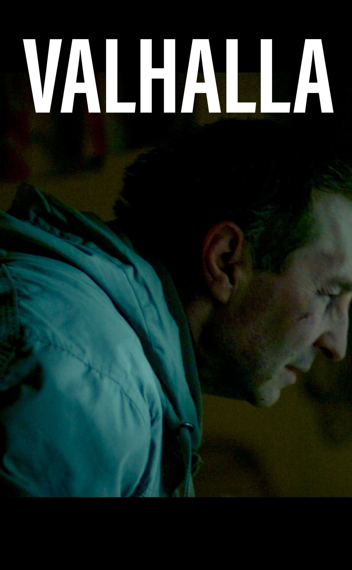 Person wearing a hooded jacket with the word VALHALLA in bold white letters above.